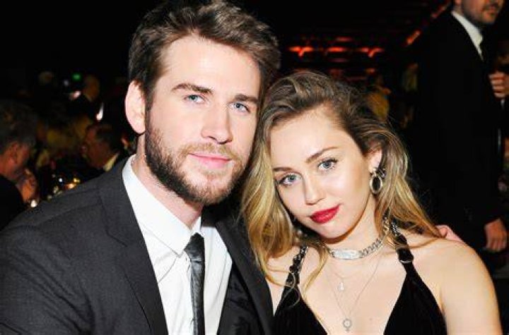 Miley Cyrus Liam Hemsworth 2019 met gala red carpet green and black dress black suit